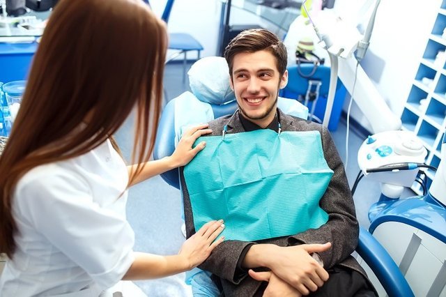 Man At The Dentists Chair During A Dental Procedure 800x533 1